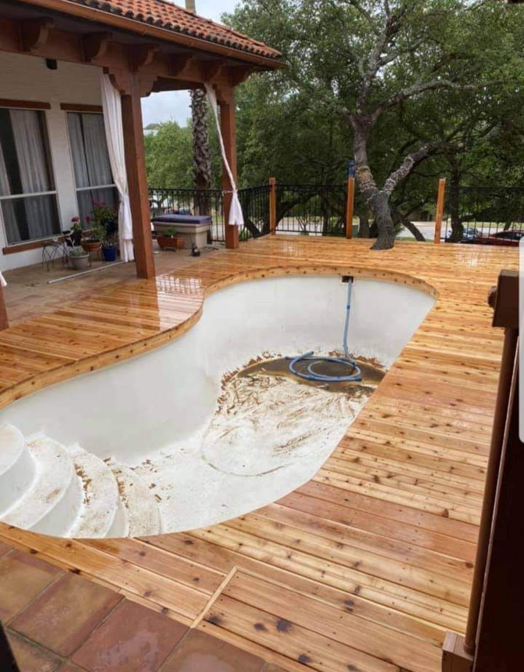 Custom wood pergola with overhead lattice built by Against the Grain Woodworks