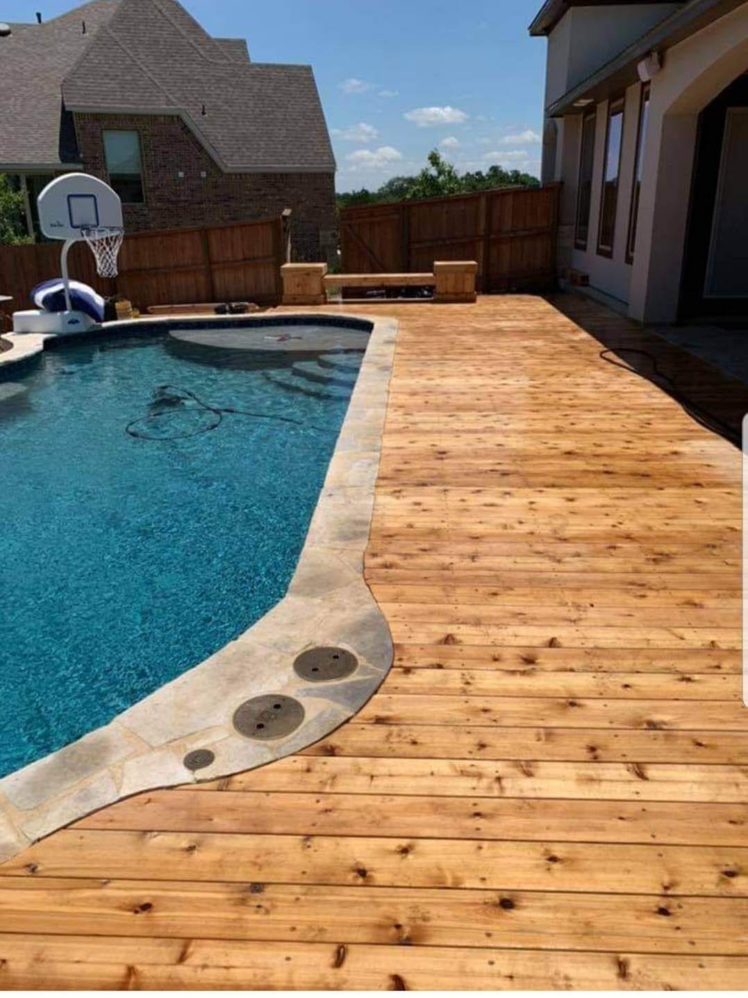 Wood fence with double gate and post caps by Against the Grain Woodworks